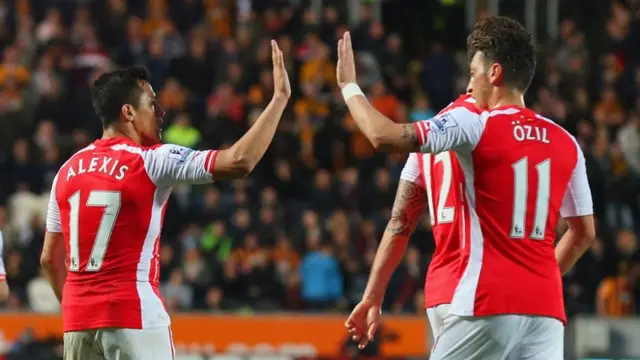 Alexis Sanchez of Arsenal celebrates with Mesut Ozil