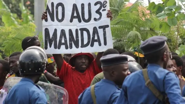 A protester holds a placard as they demonstrate against the ruling CNDD-FDD party's decision to allow Burundi President Pierre Nkurunziza to run for a third five-year term in office, in Bujumbura, 4 May 2015