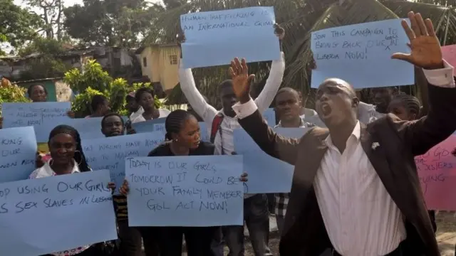 People protest near the U. Embassy against the alleged trafficking of Liberian women to Lebanon - Tuesday 28 April 2015