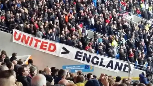 A sign reads 'United greater than England'