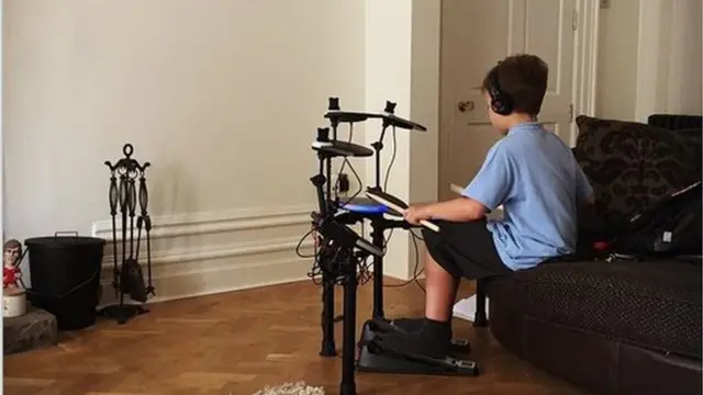 A child playing drums