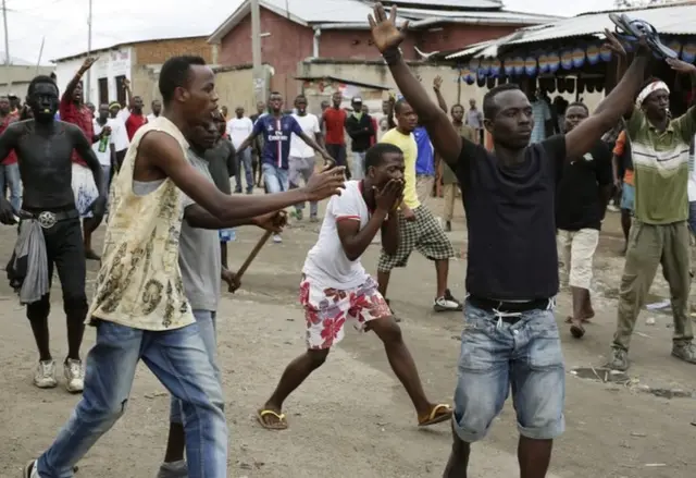 Demonstrators shout as police dismantle a barricade in the Kanyosha district of Bujumbura, Burundi, Wednesday May 6