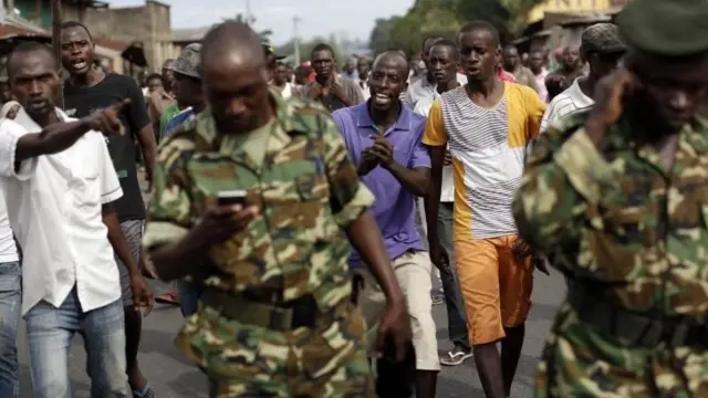 Protesters opposed to President Pierre Nkurunziza's decision to seek a third term in office shout at the army after a demonstrator was shot dead in the Kinama district of Bujumbura, Burundi - Thursday 7 May 2015