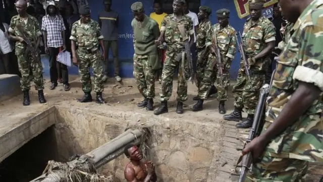 A man pleads with soldiers in Burundi