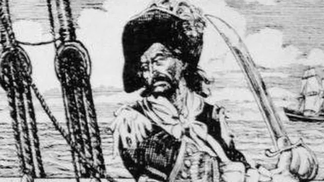 Drawing of Scottish-born American privateer and pirate William 'Captain' Kidd standing on the deck of a ship, brandishing a sword, circa 1690