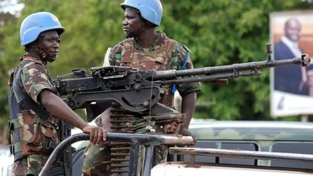 UN soldiers stand post with a machine gun on the back of a pick-up truck on 23 October 2014 in Beni