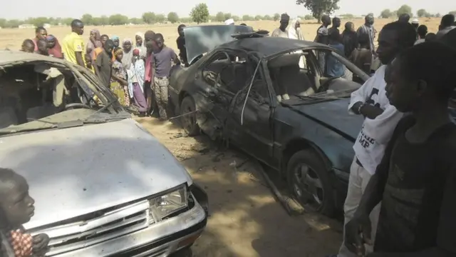 People gathered at the site of a suicide bomb attack at a car park of the College of Administrative and Business Studies in Potiskum Nigeria Friday, 8 May 2015