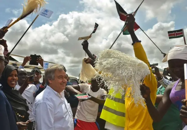 United Nations High Commissioner for Refugees Antonio Guterres (C-L) is welcomed at IFO-2 complex of the sprawling Dadaab refugee camp by South Sudan refugees performing a traditional dance on May 8, 2015