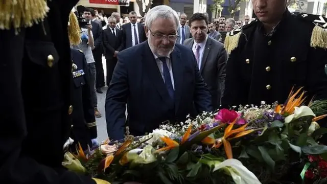 French Junior Minister for Veterans and Memory Jean-Marc Todeschini (C), lays a wreath in front of the Bouzid Saal memorial on April 19, 2015 during a visit to pay tribute to Algerian victims of Setif