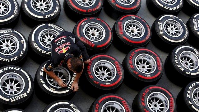 A red Bull engineer tests tyres ahead of the Spanish Grand Prix