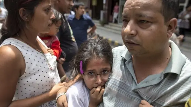 Residents evacuate onto a street minutes after the earthquake