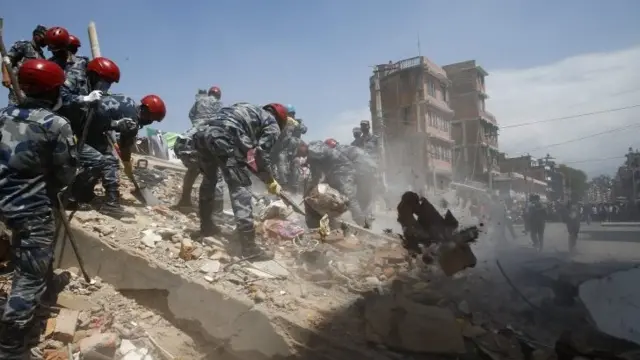 Nepalese armed police search for victims after a house collapsed