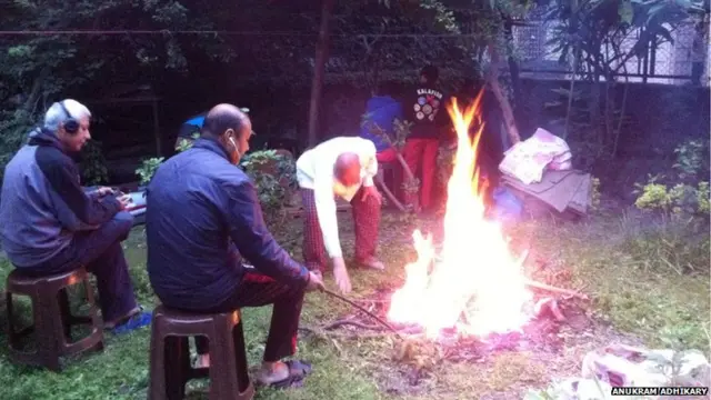 People gathering round a fire