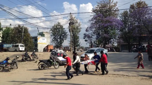 People carrying people on a stretcher