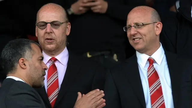 Manchester United directors Avram (centre) and Joel (right) Glazer