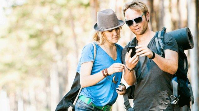 Couple on a trek using a mobile phone