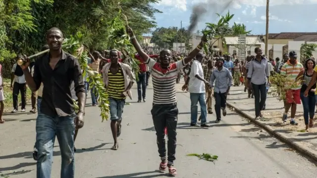 People take to the streets to celebrate, waving branches, beeping car horns and parading through Bujumbura on 13 May 2015