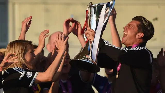 Colin Bell lifts the women's Champions League trophy