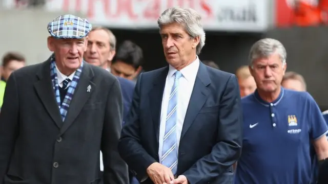 Manchester City boss Manuel Pellegrini (centre) arrives at the Liberty Stadium