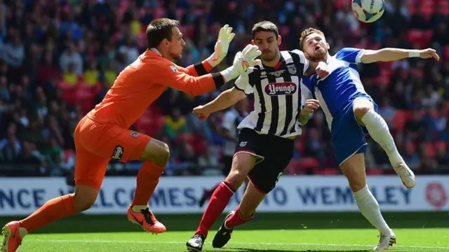 Matt Taylor of Bristol Rovers challenges for the ball with goalkeeper James McKeown and Shaun Pearson of Grimsby Town