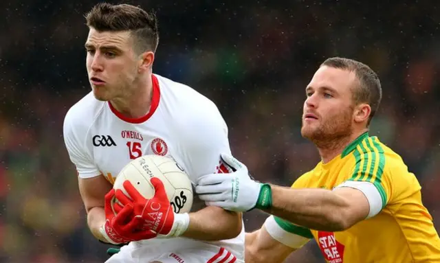 Tyrone forward Conor McAliskey is challenged by Neil McGee in the early stages at Ballybofey