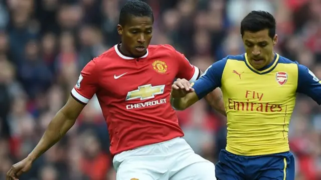 Antonio Valencia battles Sanchez for the ball