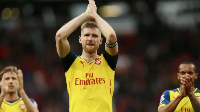 Arsenal players applaud their fans