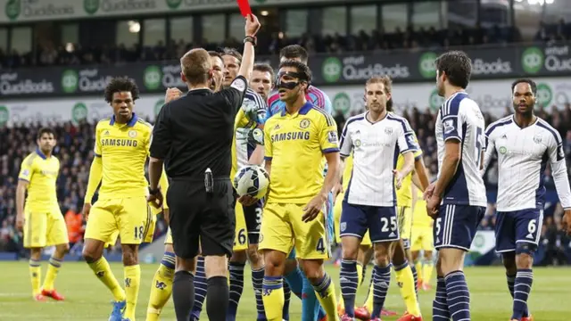 Cesc Fabregas is shown a red card