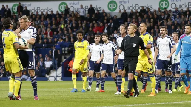 Cesc Fabregas clashes with Wrst Brom's Darren Fletcher