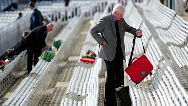 A fan takes his seat at Lords