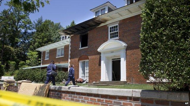 Police entering the burnt-out home