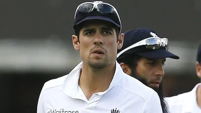 Alastair Cook looks on