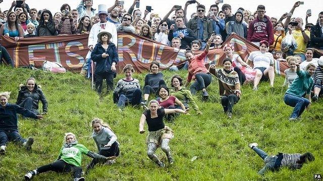 Competitors in the Cheese Rolling on Cooper's Hill race near Brockworth, Gloucestershire