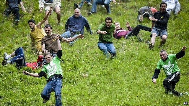 Competitors in the Cheese Rolling on Cooper's Hill race near Brockworth, Gloucestershire