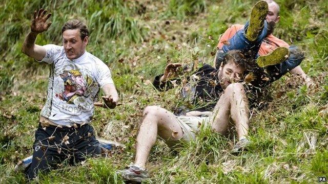 Competitors in the Cheese Rolling on Cooper's Hill race near Brockworth, Gloucestershire