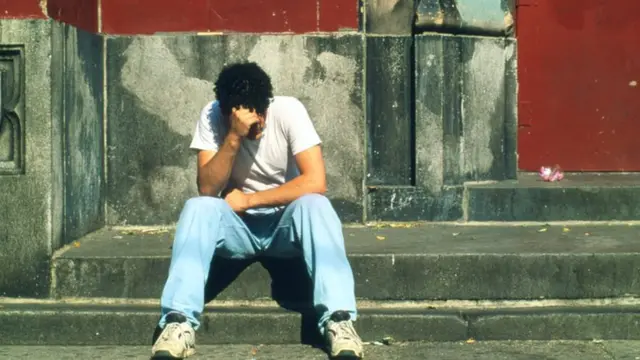 Teenager depressed on stone steps