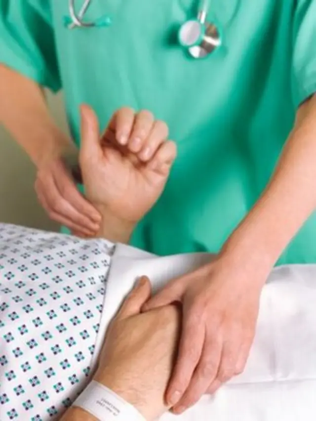 Patient having their pulse checked by a doctor