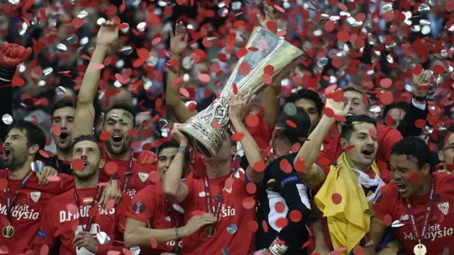 Sevilla players lift the Europa League trophy