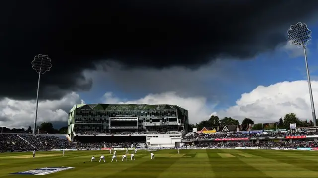 Floodlights and stormclouds