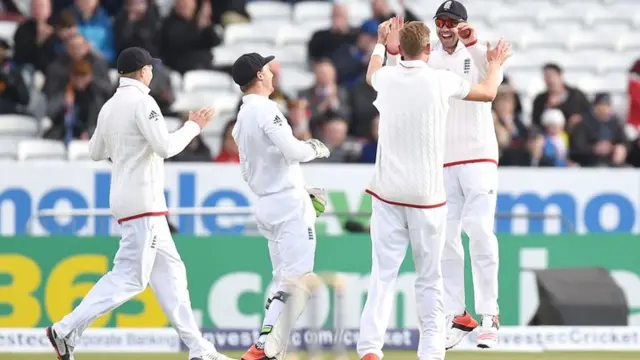 Stuart Broad celebrates with James Anderson and his team mates