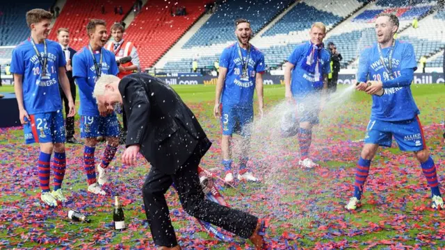 Inverness CT Chairman Kenny Cameron is sprayed with champagne as he celebrates with the trophy