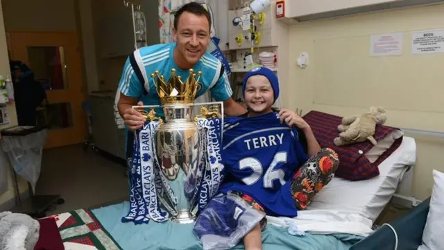 Chelsea's John Terry with a child in a Sydney hospital