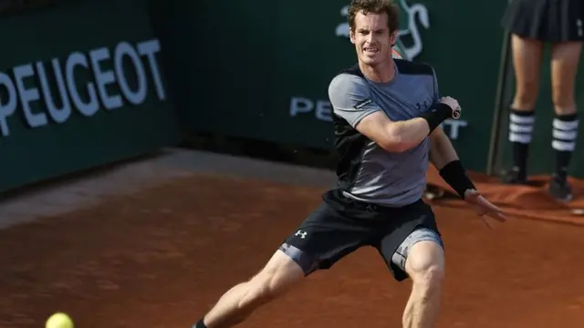 Andy Murray returns a ball