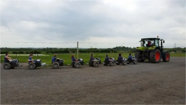 Tractor pulling the Cumbria Uni singers