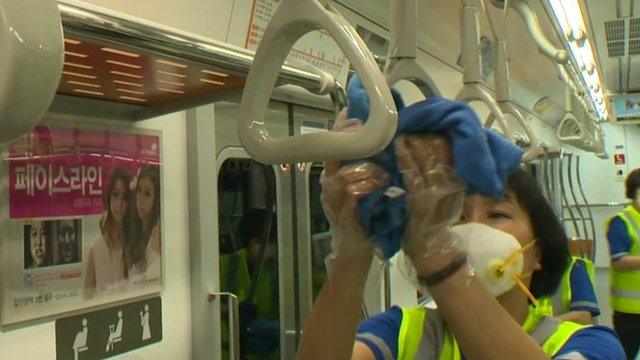 Woman cleaning on train in Seoul