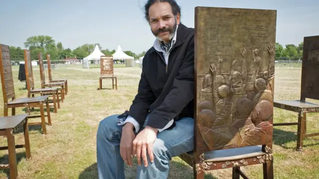 Hew Locke with his artwork, The Jurors
