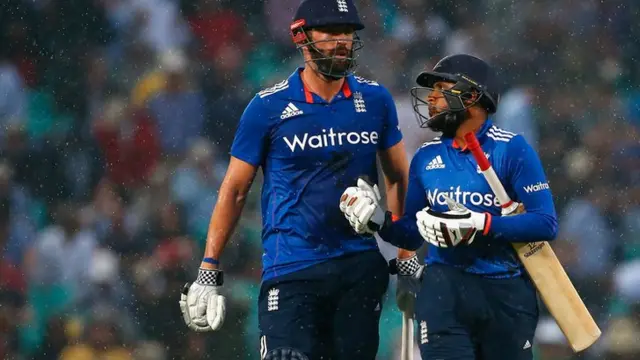 Liam Plunkett and Adil Rashid leave the field during the rain