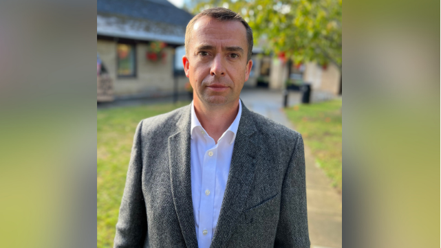 Calum Miller, MP for Bicester and Woodstock, outside Exeter Hall in Kidlington where the public event took place. He is looking straight into the camera.