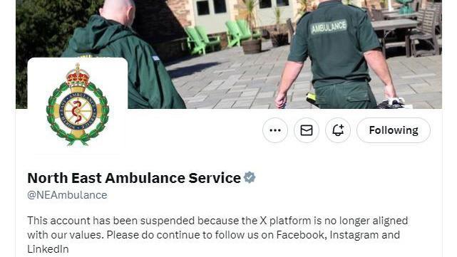 A grab of the NEAS account page on X, with the ambulance logo, a picture of two male paramedics walking away from the camera and a statement saying "This account has been suspended because the X platform is no longer aligned with our values"