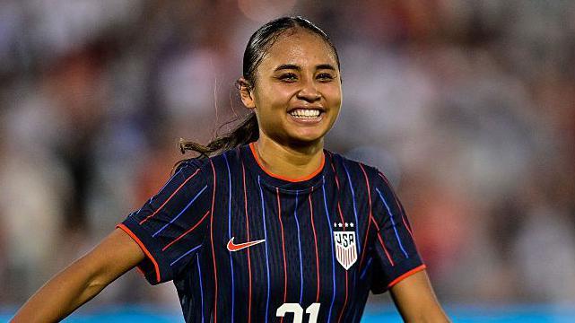Alyssa Thompson smiling in USA kit